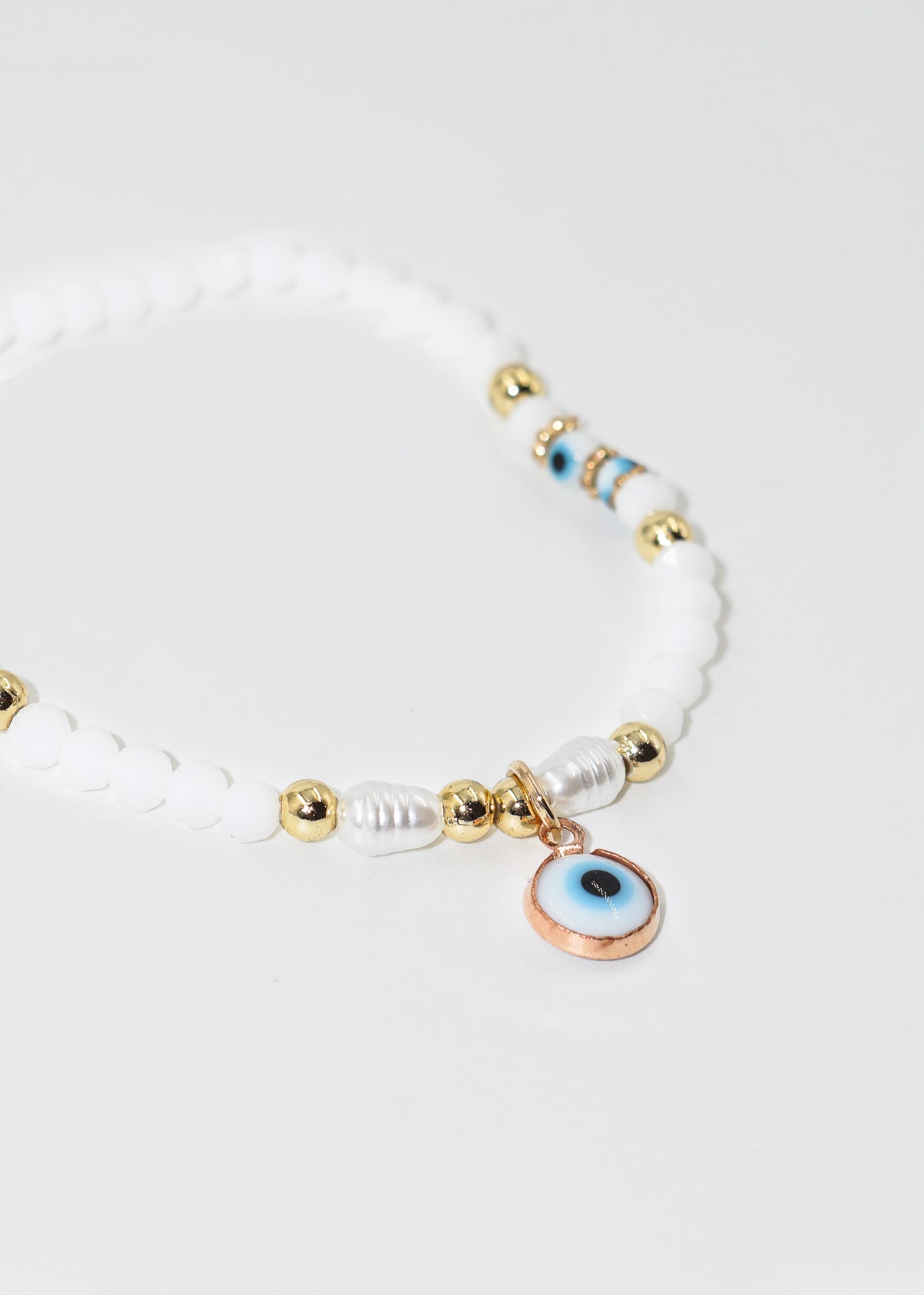 Pulsera mostacillas con dije ojo turco colgante elastizada