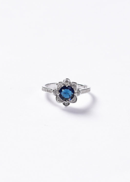 Anillo flor azul con zirconias laterales plata 925
