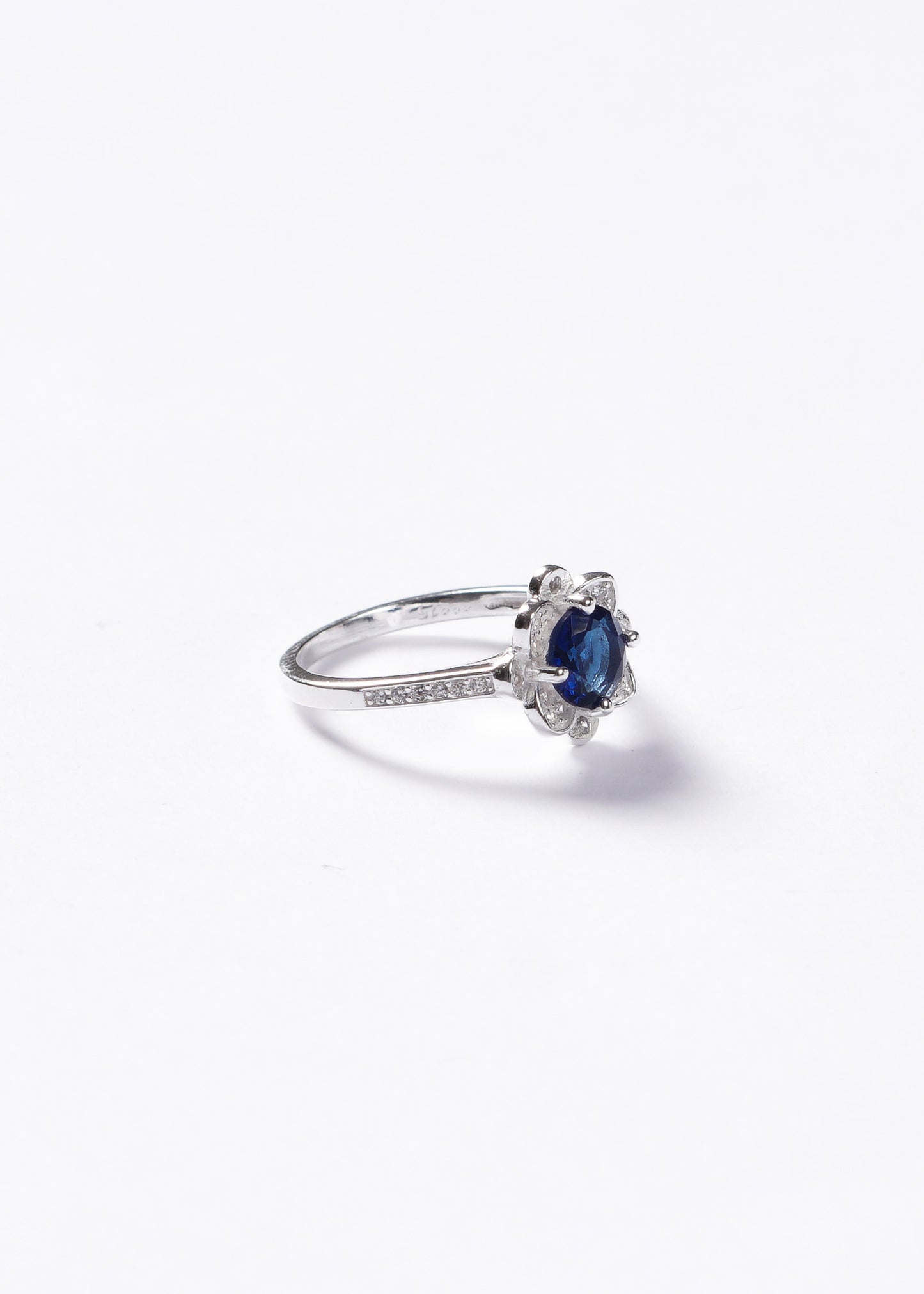 Anillo flor azul con zirconias laterales plata 925