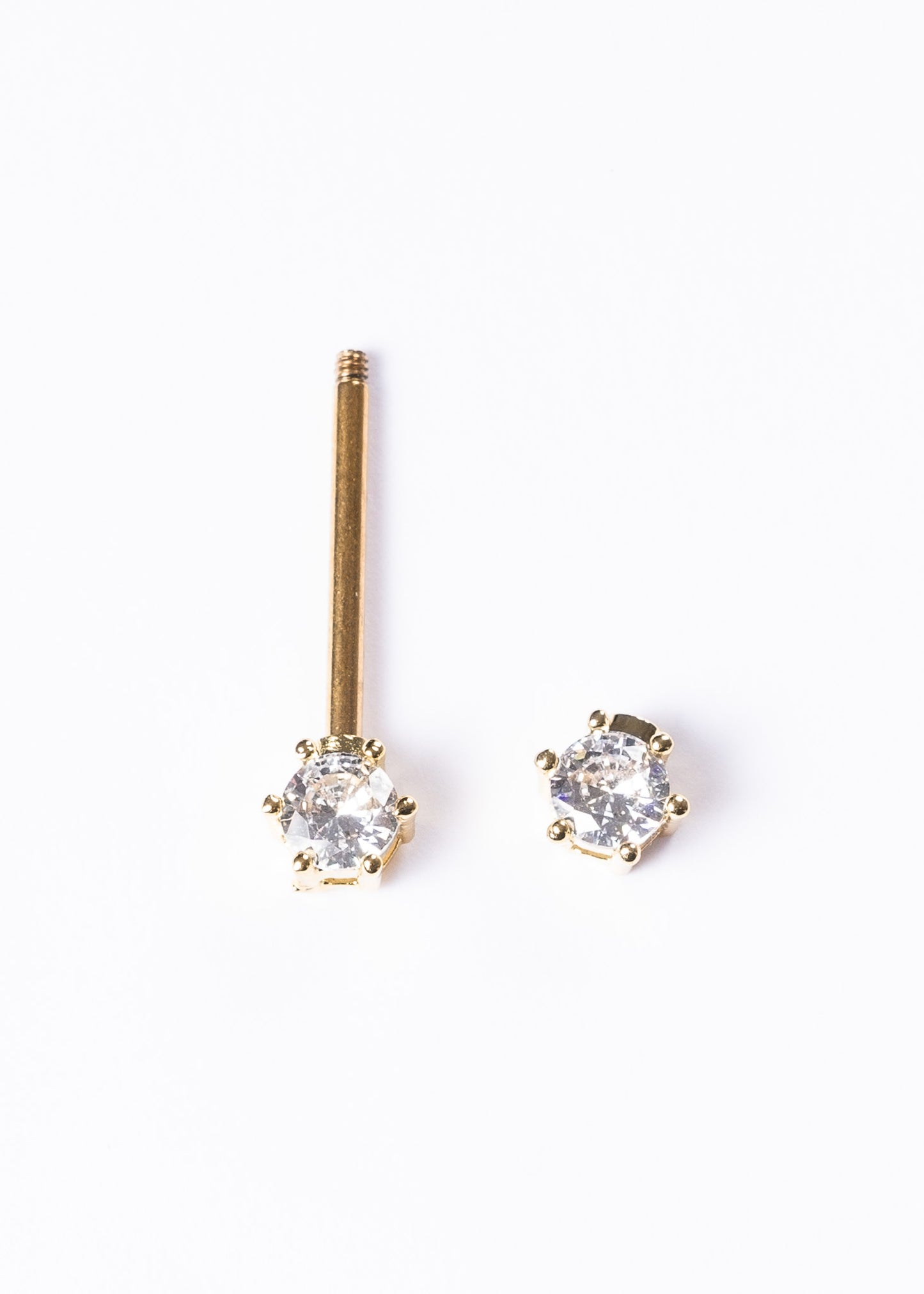 Piercing barra con zirconias para pezón acero quirúrgico dorado