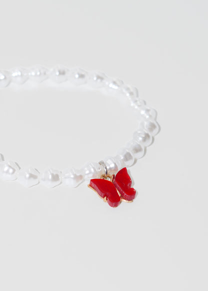 Pulsera perlas y dje mariposa elastizada